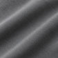 A close-up of dark gray ribbed knit fabric with soft diagonal folds showing the texture and weave.